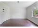 Bedroom boasts hardwood floors, closet, and a window overlooking lush greenery at 172 Forest Nw Ln, Marietta, GA 30064