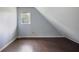 Attic bedroom featuring dark wood floors, a window, and angled ceilings at 172 Forest Nw Ln, Marietta, GA 30064