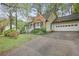 View of house, driveway and garage featuring traditional architecture with lovely landscaping and mature trees at 172 Forest Nw Ln, Marietta, GA 30064