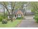 Charming home with manicured front yard and a paved driveway leading to the garage at 172 Forest Nw Ln, Marietta, GA 30064