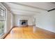 Spacious living room featuring hardwood floors, stone fireplace, and large windows offering natural light at 172 Forest Nw Ln, Marietta, GA 30064