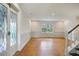 Living room with wood floors, statement glass doors and large window looking out onto the yard at 172 Forest Nw Ln, Marietta, GA 30064