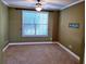 Carpeted bedroom offering ample natural light from a large window and a ceiling fan at 1910 Cedar Glenn Way # 4104, Atlanta, GA 30339