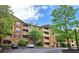 Attractive building exterior with multiple stories and private balconies, surrounded by mature trees at 1910 Cedar Glenn Way # 4104, Atlanta, GA 30339