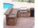 Outdoor kitchen area featuring a built-in grill, sink, and convenient trash receptacle at 1910 Cedar Glenn Way # 4104, Atlanta, GA 30339