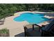 A clover-shaped outdoor pool on a sunny day, surrounded by greenery and lounge chairs at 1910 Cedar Glenn Way # 4104, Atlanta, GA 30339