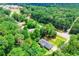 Overhead shot of landscaped home nestled among green trees near a road at 5950 Central Church Rd, Douglasville, GA 30135