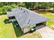 Aerial view showcasing the new roof of this charming single-story home, featuring a screened-in porch at 5950 Central Church Rd, Douglasville, GA 30135