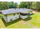 Expansive backyard featuring a screened-in porch, freshly cut green grass, and a white brick house at 5950 Central Church Rd, Douglasville, GA 30135