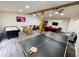 Finished basement featuring a ping pong table, pool table, and game machines at 5950 Central Church Rd, Douglasville, GA 30135