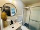 Bathroom featuring a shower and sliding glass door, a round mirror, and decorative accents at 5950 Central Church Rd, Douglasville, GA 30135