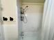 Standard white tiled bathtub and shower combination at 5950 Central Church Rd, Douglasville, GA 30135