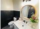 The bathroom features a vessel sink, a framed round mirror, and paneling at 5950 Central Church Rd, Douglasville, GA 30135