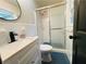 Bathroom featuring a shower with sliding doors, a round mirror, and a black faucet at 5950 Central Church Rd, Douglasville, GA 30135