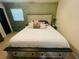 Bedroom with a king bed, storage drawers, and a ceiling fan with lights at 5950 Central Church Rd, Douglasville, GA 30135