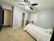 Bedroom with carpet, a bed, a ceiling fan, and access to closet and hallway at 5950 Central Church Rd, Douglasville, GA 30135