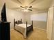 This bedroom includes a ceiling fan, plush carpet, and a view to the backyard at 5950 Central Church Rd, Douglasville, GA 30135