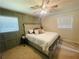 Bedroom featuring wainscotting, a window with blinds, carpet, and a ceiling fan with lights at 5950 Central Church Rd, Douglasville, GA 30135