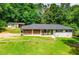 Charming single-story home featuring a bright green front door and meticulously manicured lawn at 5950 Central Church Rd, Douglasville, GA 30135
