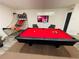 Spacious game room featuring a red billiards table, basketball game, and wall-mounted TV for entertainment at 5950 Central Church Rd, Douglasville, GA 30135