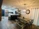 The kitchen features stainless steel appliances, an island, modern lighting, and an adjacent dining area at 5950 Central Church Rd, Douglasville, GA 30135