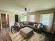 The living room features a comfortable couch and a geometric ottoman, and luxury vinyl flooring at 5950 Central Church Rd, Douglasville, GA 30135