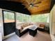 Relaxing screened-in sunroom featuring a ceiling fan and an outdoor view at 5950 Central Church Rd, Douglasville, GA 30135
