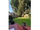 Spacious backyard with a wooden deck, mature trees, and a privacy fence at 10825 Pinewalk Forest Cir, Alpharetta, GA 30022