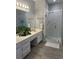 Bathroom features white cabinets, double sinks, a large mirror, and a glass-enclosed walk-in shower at 10825 Pinewalk Forest Cir, Alpharetta, GA 30022