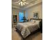 Comfortable bedroom features a queen bed, a tray ceiling, a window, and a plant at 10825 Pinewalk Forest Cir, Alpharetta, GA 30022