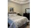 Cozy bedroom with a queen-sized bed, a dark wood dresser, a bedside table, and neutral decor at 10825 Pinewalk Forest Cir, Alpharetta, GA 30022