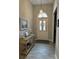 Inviting foyer featuring tile floors, console table, and decorative lighting at 10825 Pinewalk Forest Cir, Alpharetta, GA 30022