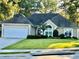Charming single-story home with a well-manicured lawn, attached garage, and inviting curb appeal at 10825 Pinewalk Forest Cir, Alpharetta, GA 30022