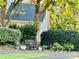 Charming home exterior with lush landscaping and seating area, showcasing curb appeal at 10825 Pinewalk Forest Cir, Alpharetta, GA 30022