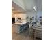 Bright kitchen boasts white cabinetry, a stylish island with bar seating, and an open dining area at 10825 Pinewalk Forest Cir, Alpharetta, GA 30022