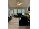Comfortable living room with a ceiling fan, tile floors, and ample natural light at 10825 Pinewalk Forest Cir, Alpharetta, GA 30022