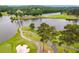 Aerial view of community golf course, lake, walking paths, and bridge at 2012 Golfers Way, Villa Rica, GA 30180