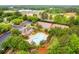Overhead view of the community with tennis courts, a pool, a clubhouse, parking and a playground nestled in mature trees at 2012 Golfers Way, Villa Rica, GA 30180