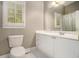 Cozy bathroom with white vanity, tile floors, and a large mirror at 2012 Golfers Way, Villa Rica, GA 30180