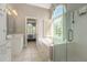Bright bathroom features a large soaking tub, glass enclosed shower, and a view of the outdoors at 2012 Golfers Way, Villa Rica, GA 30180
