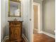 Charming powder room features a decorative vanity with a marble countertop at 2012 Golfers Way, Villa Rica, GA 30180