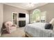Bright bedroom with neutral walls, a large window, and a plush armchair at 2012 Golfers Way, Villa Rica, GA 30180