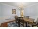 Stylish dining room with wainscoting, chandelier, and light blue walls at 2012 Golfers Way, Villa Rica, GA 30180