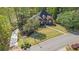 Beautiful brick home with a manicured lawn, mature trees, and a curved driveway in a serene, lush setting at 2012 Golfers Way, Villa Rica, GA 30180