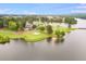 Stunning aerial view of a lush golf course situated along a serene lake with beautiful trees and a charming clubhouse nearby at 2012 Golfers Way, Villa Rica, GA 30180