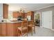 Spacious kitchen with wood cabinets, bar seating and stainless steel appliances at 2012 Golfers Way, Villa Rica, GA 30180