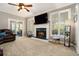 Cozy living room features a fireplace, large windows, and comfortable seating at 2012 Golfers Way, Villa Rica, GA 30180