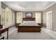 Serene main bedroom with large windows, natural light and tray ceiling at 2012 Golfers Way, Villa Rica, GA 30180
