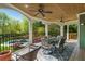 Covered patio with a table, seating, ceiling fans and view of the backyard pool at 2012 Golfers Way, Villa Rica, GA 30180