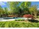 Backyard featuring a luxurious pool, spa, and outdoor seating areas for relaxing at 2012 Golfers Way, Villa Rica, GA 30180